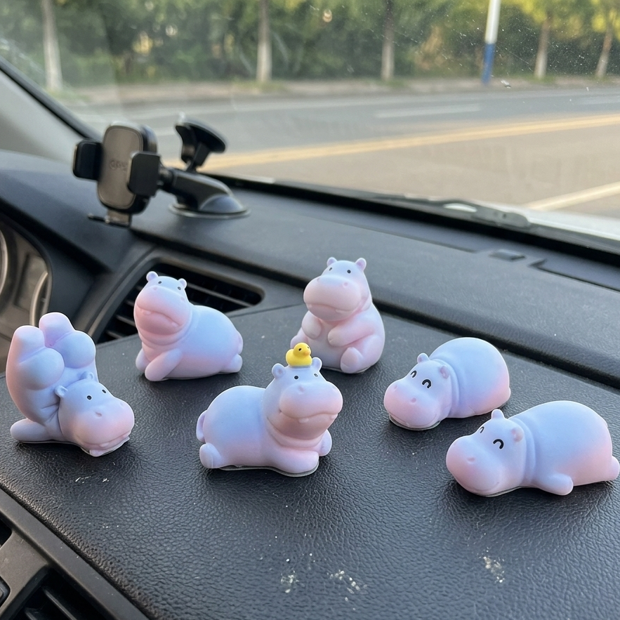 Six cute chubby cartoon hippo gradient color resin figurines for car dashboard, shown with included double-sided adhesive tapes for secure mounting.