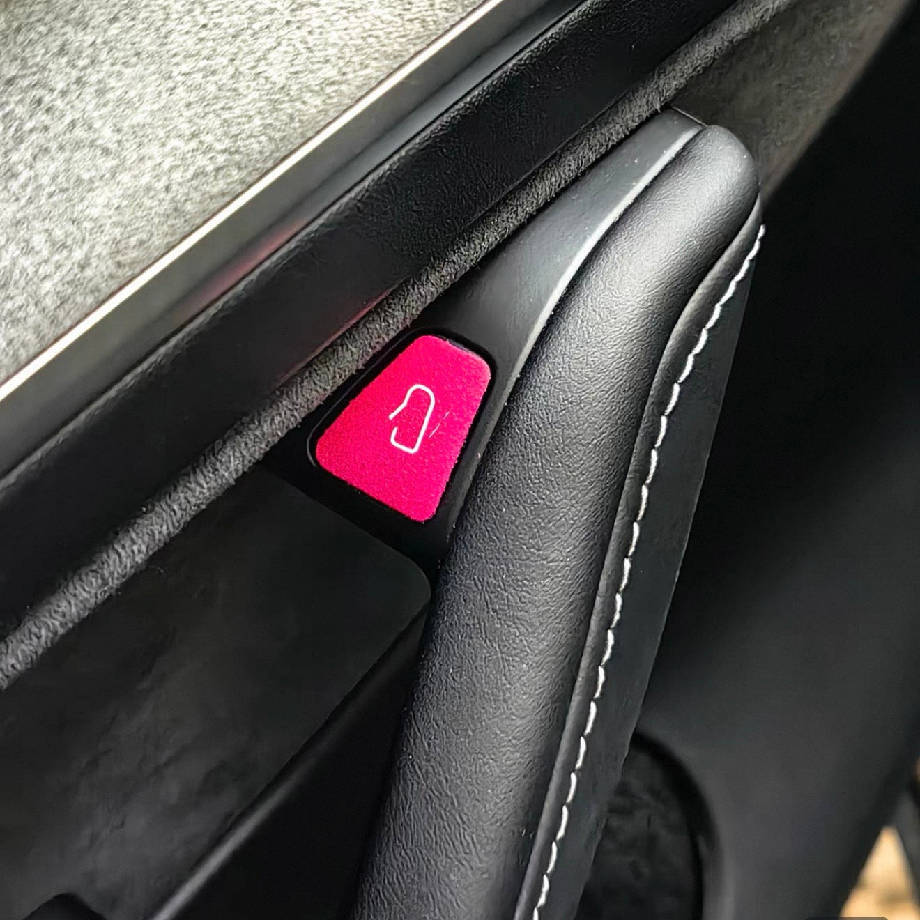 Premium colorful suede door open button cover stickers applied to a Tesla interior door panel, showing a precise cut matching the door release switch.