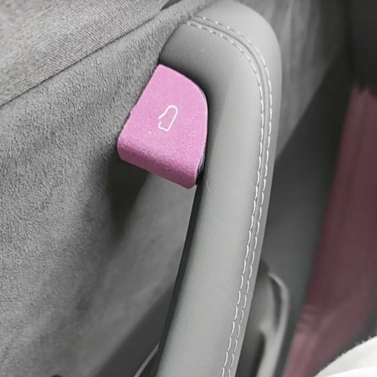 Premium colorful suede door open button cover stickers applied to a Tesla interior door panel, showing a precise cut matching the door release switch.