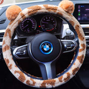 Beige and brown plush steering wheel cover with cute bear ears installed on car steering wheel