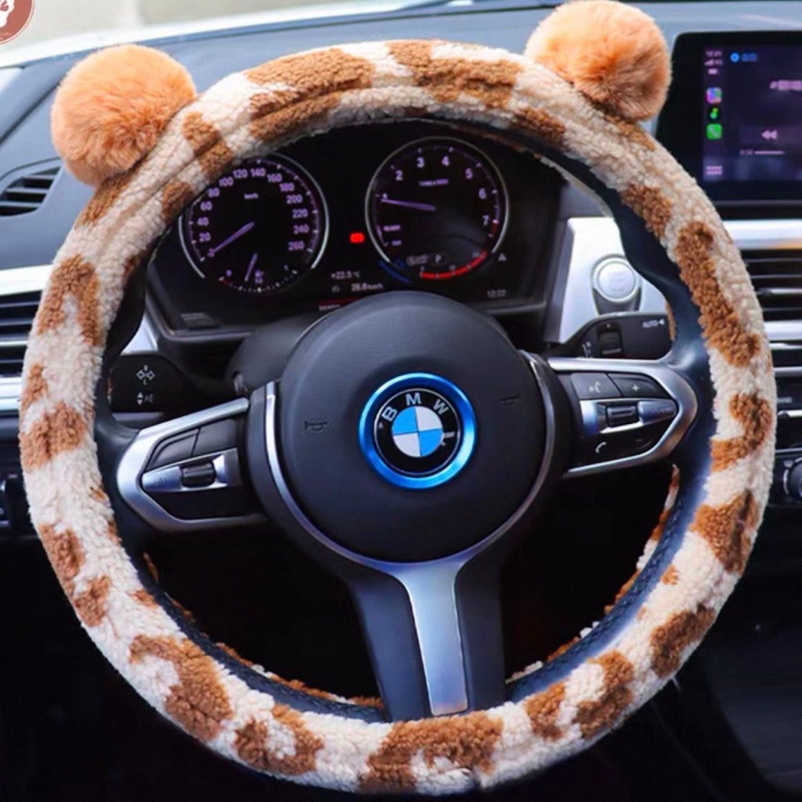 Beige and brown plush steering wheel cover with cute bear ears installed on car steering wheel