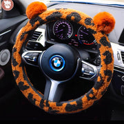 Orange and black leopard print fluffy steering wheel cover with bear ears on BMW steering wheel