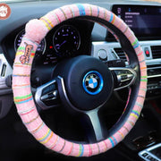 Boho striped fabric steering wheel covers with dachshund patches and fluffy pom poms in Pink