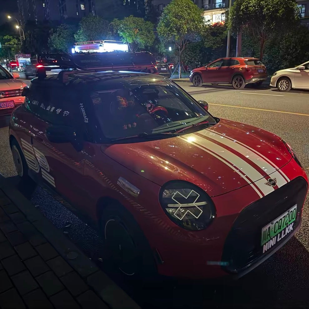 White X headlight decal sticker applied to Mini Cooper front headlights showing comic manga style effect