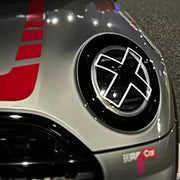 White X headlight decal sticker applied to Mini Cooper front headlights showing comic manga style effect close up