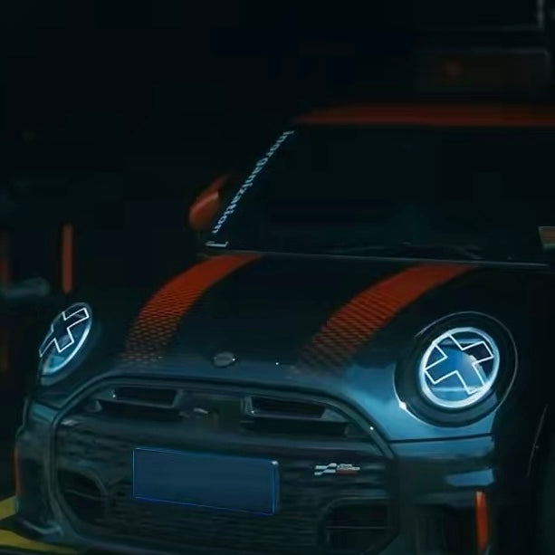 White X headlight decal sticker applied to Mini Cooper front headlights showing comic manga style effect