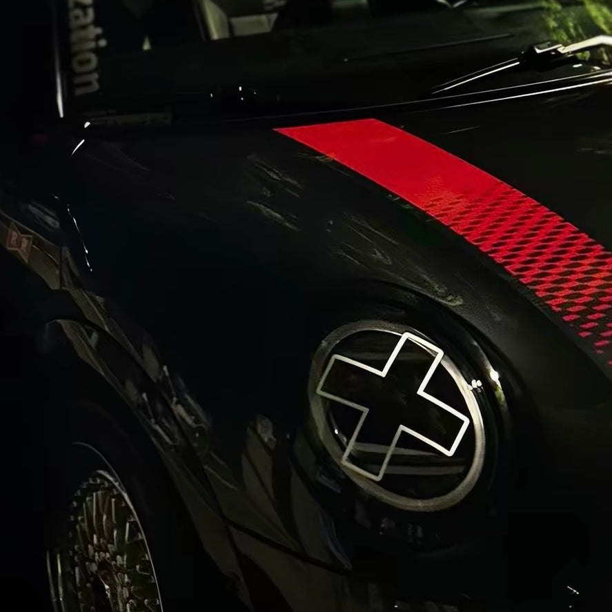 White X headlight decal sticker applied to Mini Cooper front headlights showing comic manga style effect