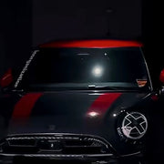 White X headlight decal sticker applied to Mini Cooper front headlights showing comic manga style effect