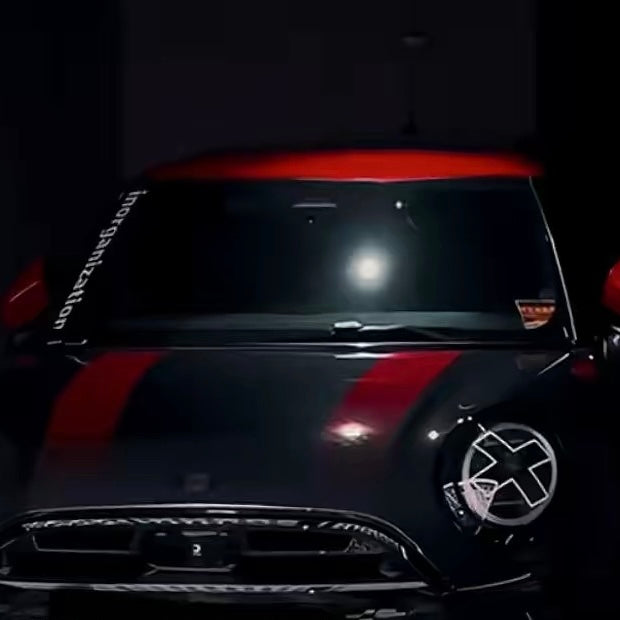 White X headlight decal sticker applied to Mini Cooper front headlights showing comic manga style effect