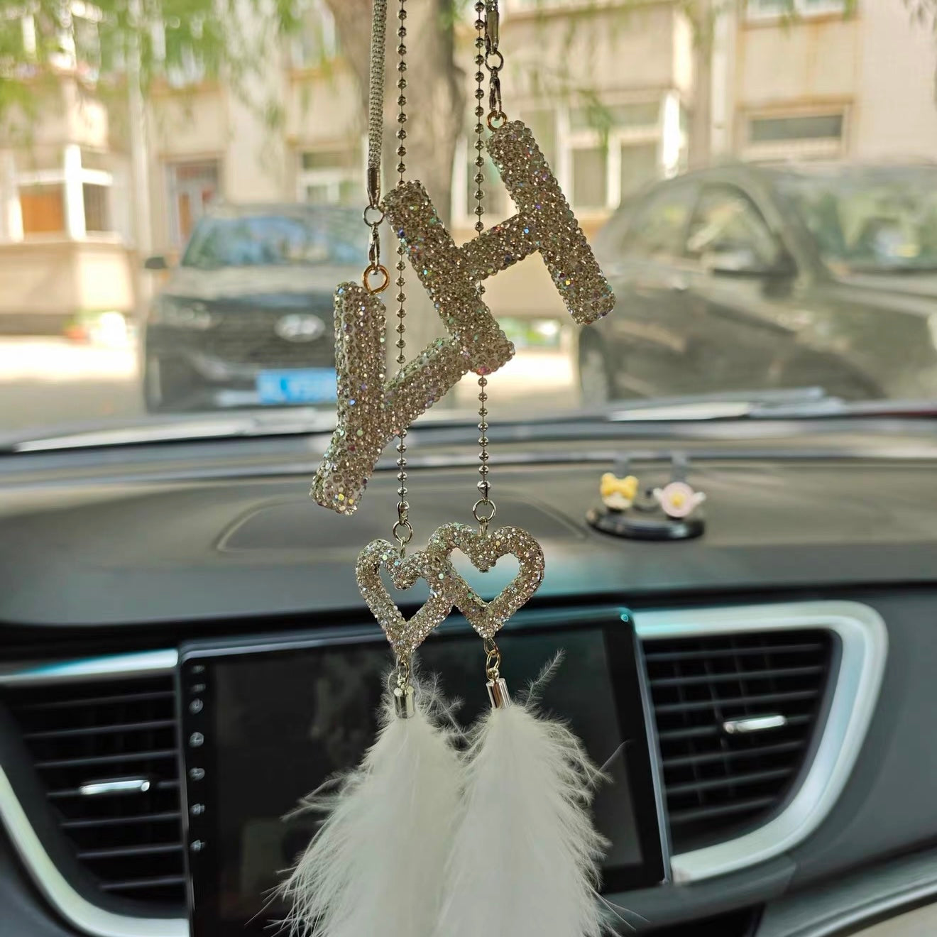Two matching rhinestone initial car charms hanging side by side on rearview mirror as a personalized pair set