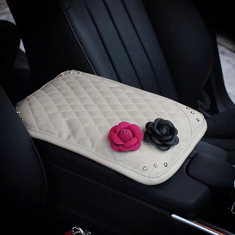 a red and white cake sitting on top of a car 
