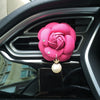 a pink teddy bear on the dashboard of a car 