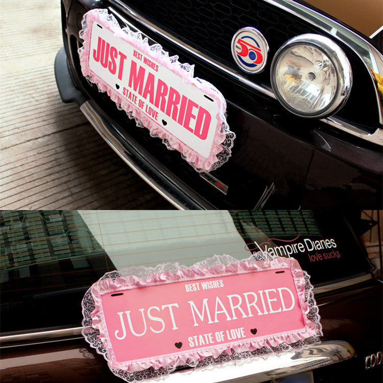 a red and white sign sitting on top of a car 